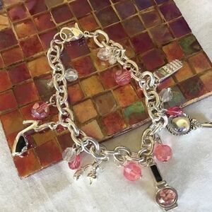 $12 ea of 3/$25. Silvertone “Girly” Charm Bracelet